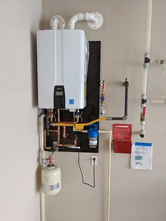 Professional plumber installing copper piping in a Warwick home